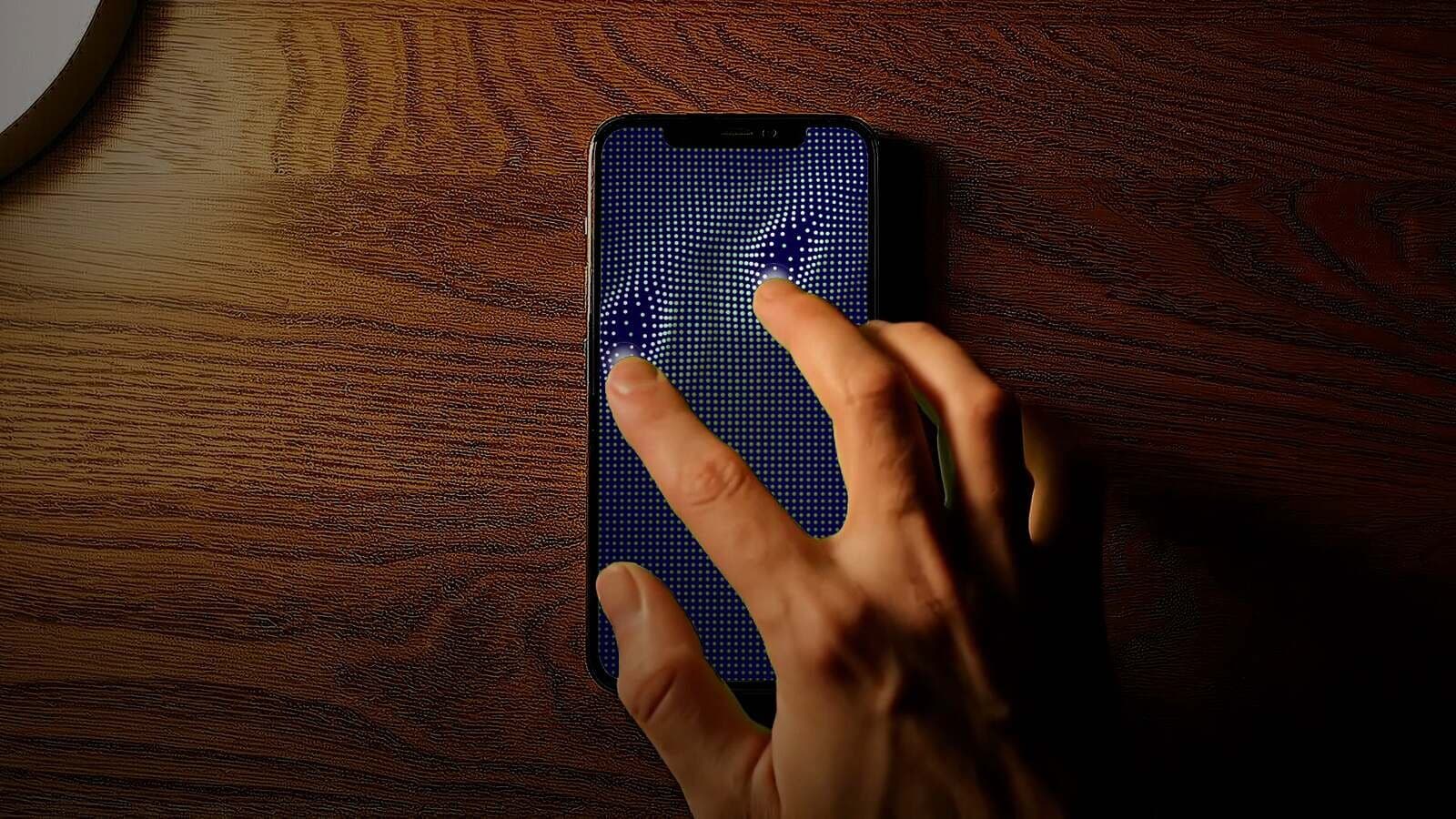 Hand resting on an iPhone running SoundFidget